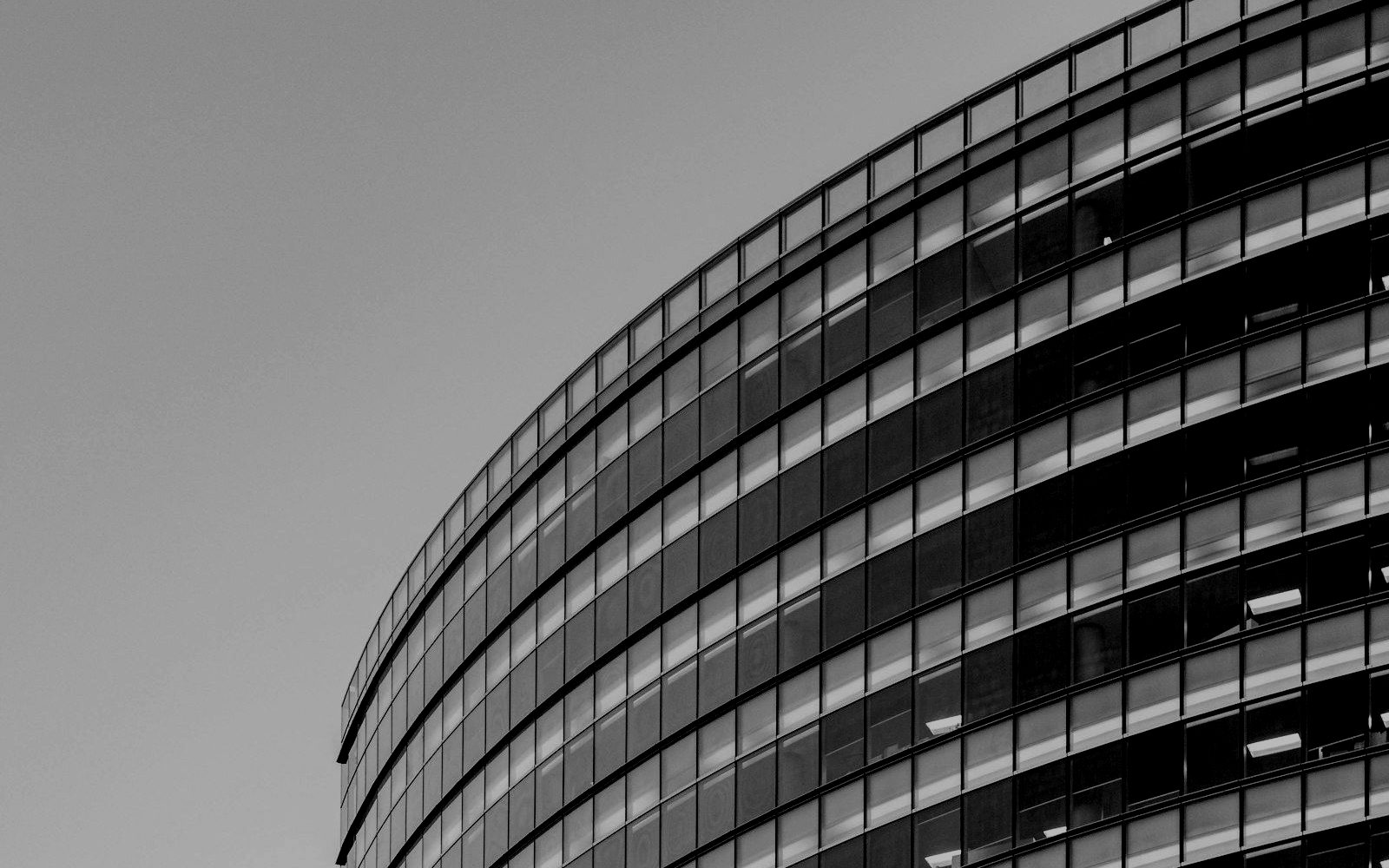 The curved glass facade of an office building