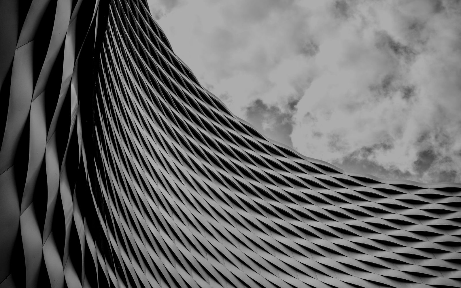 A curving steel lattice against the sky