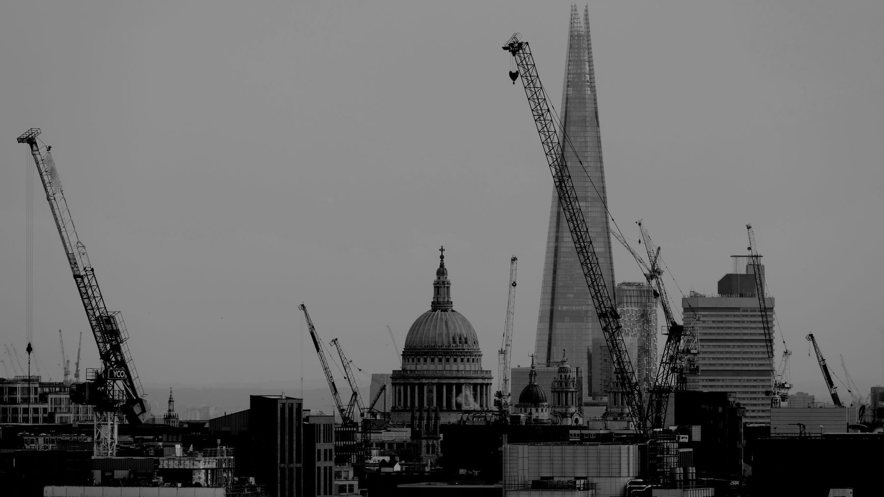 Tower cranes beside St Paul's Cathedral and the Shard in London