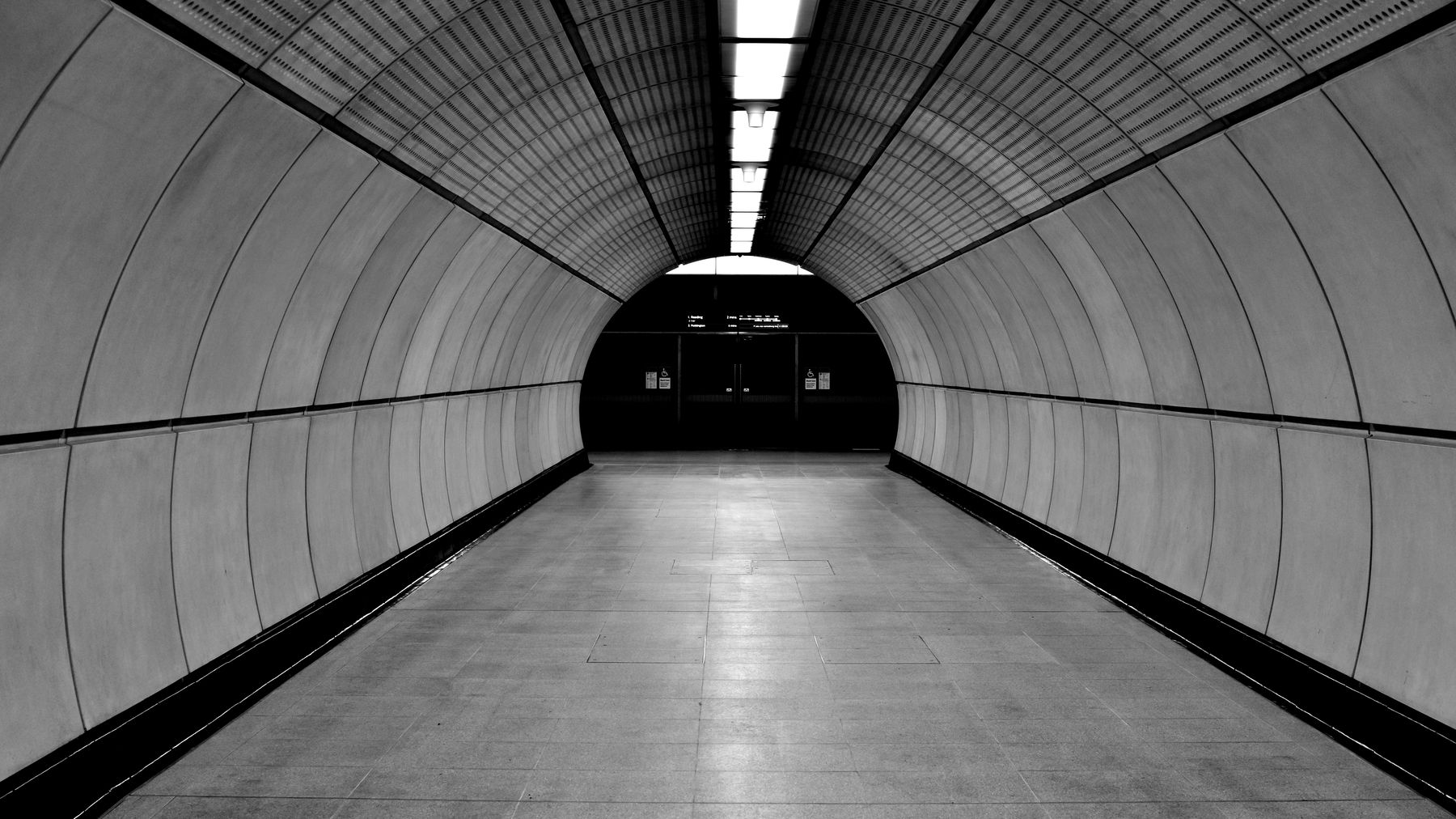 A curved Elizabeth line platform tunnel in London